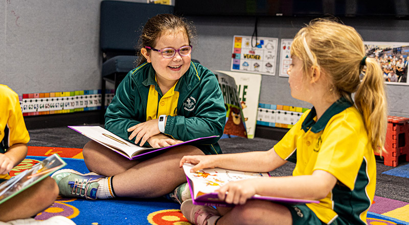 Students laughing and reading at Corpus Christi Catholic Primary School Cranebrook